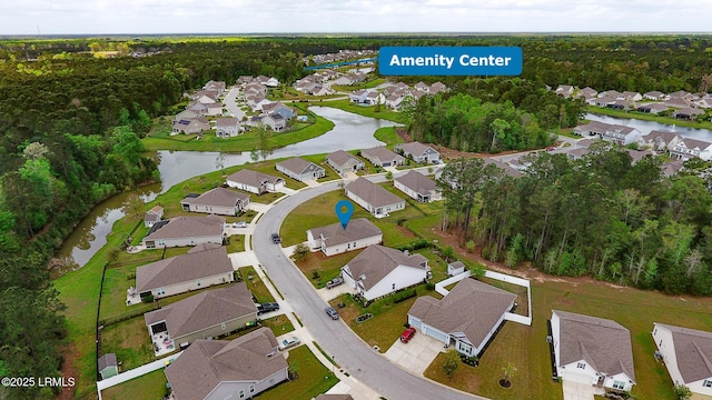drone / aerial view featuring a residential view and a water view
