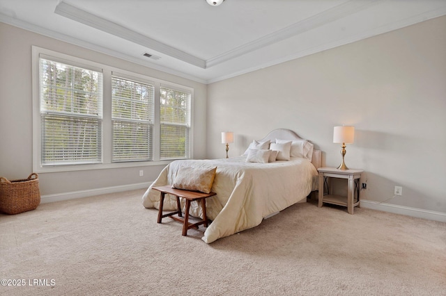 carpeted bedroom with baseboards, ornamental molding, visible vents, and a raised ceiling