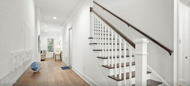 stairway with recessed lighting, crown molding, baseboards, and wood finished floors