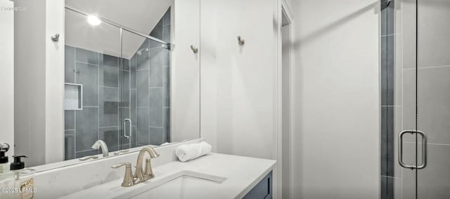 bathroom with vanity and a shower stall