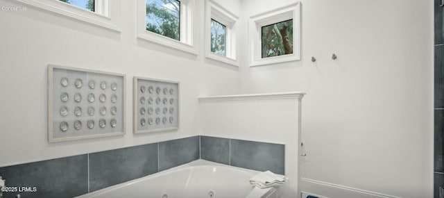 full bath with a tub with jets