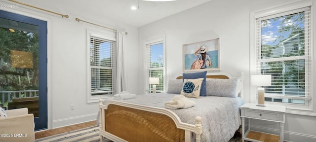 bedroom featuring wood finished floors and baseboards