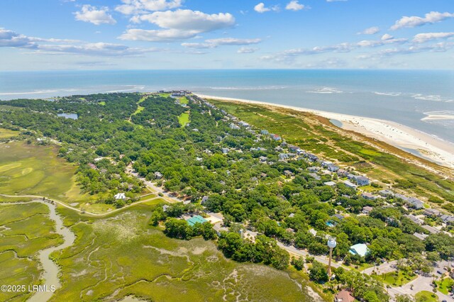 birds eye view of property with a water view and a beach view