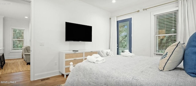 bedroom with visible vents, baseboards, wood finished floors, and recessed lighting