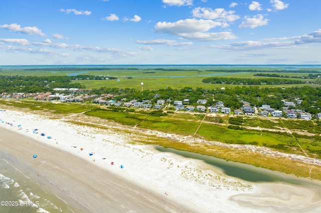 bird's eye view featuring a water view and a beach view