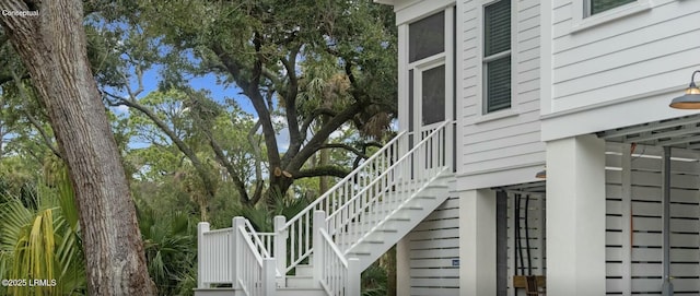 view of side of home featuring stairs
