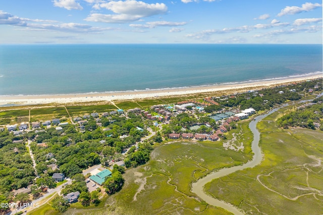 bird's eye view featuring a water view and a beach view