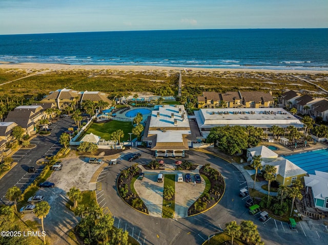 drone / aerial view with a water view and a beach view