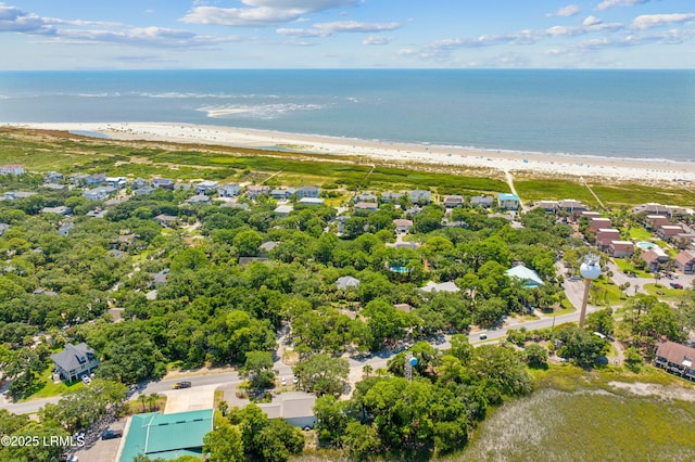 drone / aerial view featuring a water view and a beach view