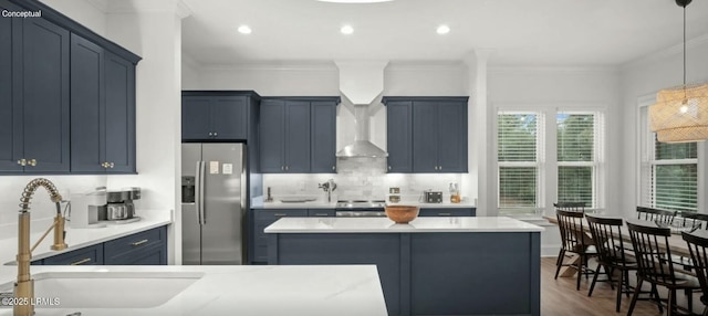 kitchen with stainless steel appliances, decorative backsplash, light countertops, and pendant lighting