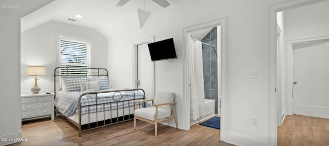 bedroom with visible vents, vaulted ceiling, and wood finished floors