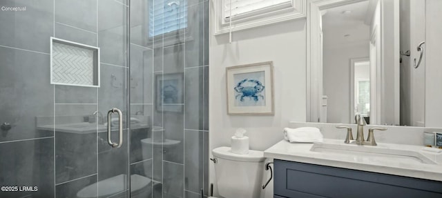 bathroom featuring toilet, a shower stall, and vanity