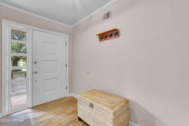 entrance foyer featuring ornamental molding and light wood-type flooring