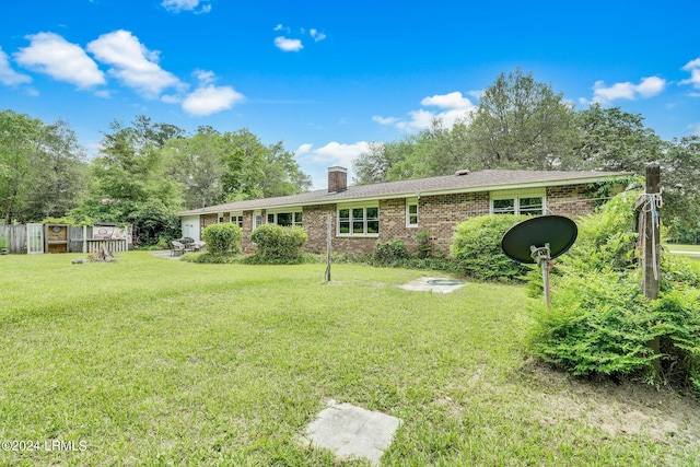 rear view of house with a yard