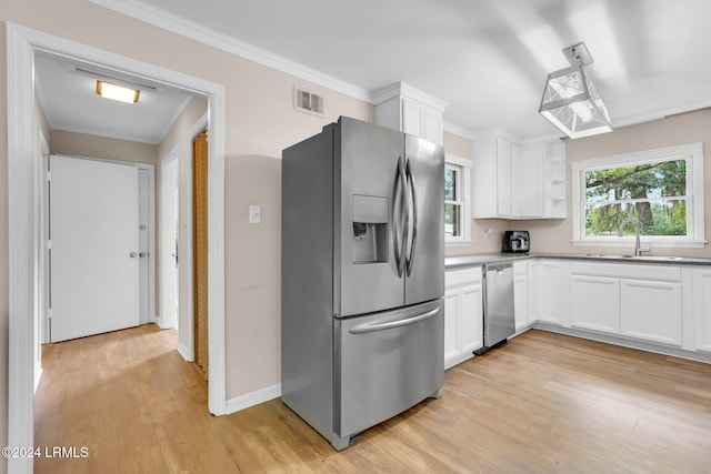 kitchen featuring sink, light wood-type flooring, white cabinets, and appliances with stainless steel finishes