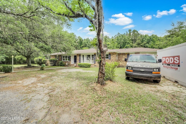 single story home featuring a front lawn