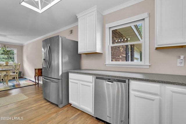 kitchen featuring white cabinetry, ornamental molding, stainless steel appliances, and light wood-type flooring