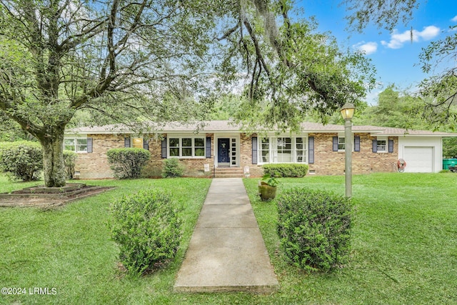 single story home with a garage and a front yard