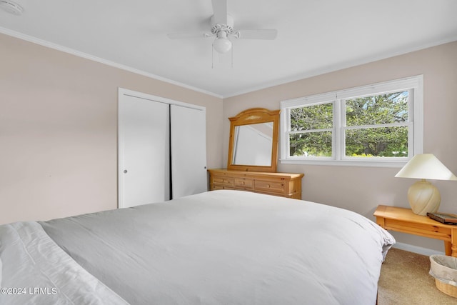 carpeted bedroom featuring a closet and ceiling fan