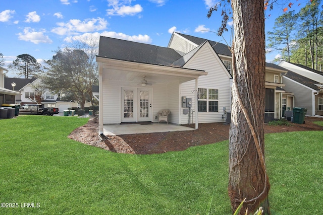 back of property featuring a patio area, ceiling fan, french doors, and a yard