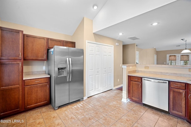 kitchen featuring pendant lighting, stainless steel appliances, lofted ceiling, light countertops, and visible vents