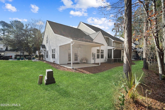 back of property with a patio area, a lawn, and ceiling fan