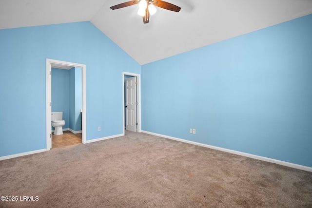 unfurnished bedroom with light carpet, baseboards, lofted ceiling, ceiling fan, and ensuite bathroom