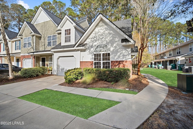 multi unit property with a garage and a front yard