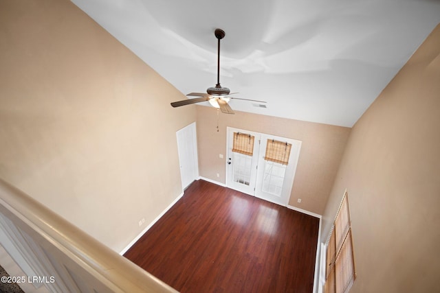 interior space with lofted ceiling, dark wood-style floors, visible vents, and baseboards