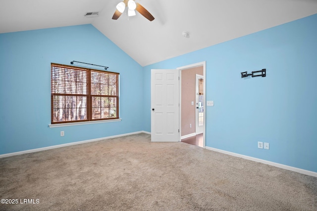 carpeted spare room with lofted ceiling, ceiling fan, visible vents, and baseboards