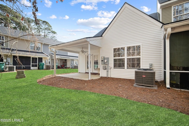 back of house with a patio area, a lawn, and central AC unit