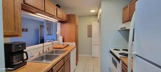 kitchen with sink, white appliances, and light tile patterned flooring
