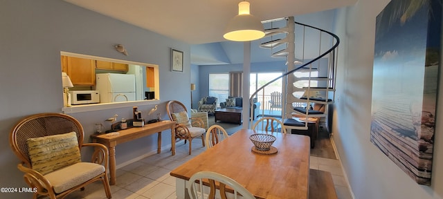 tiled dining area with lofted ceiling