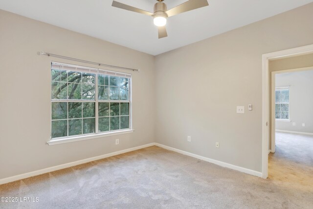 carpeted spare room with ceiling fan