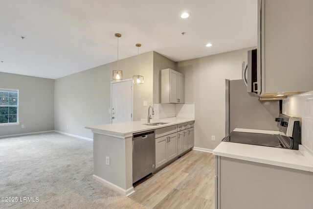 kitchen with pendant lighting, sink, appliances with stainless steel finishes, gray cabinetry, and decorative backsplash