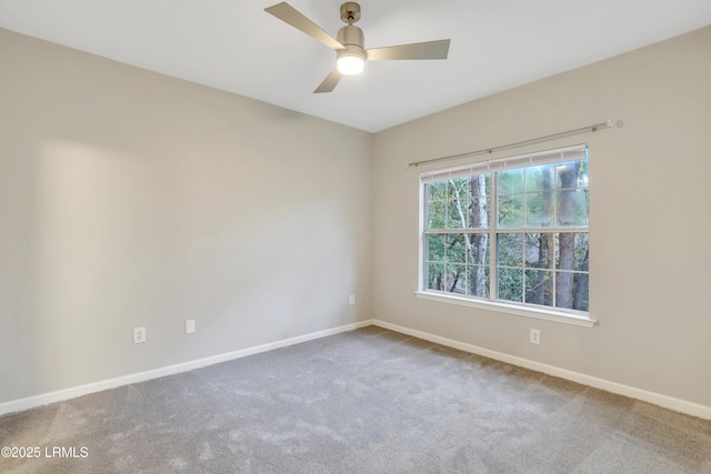 carpeted spare room with ceiling fan