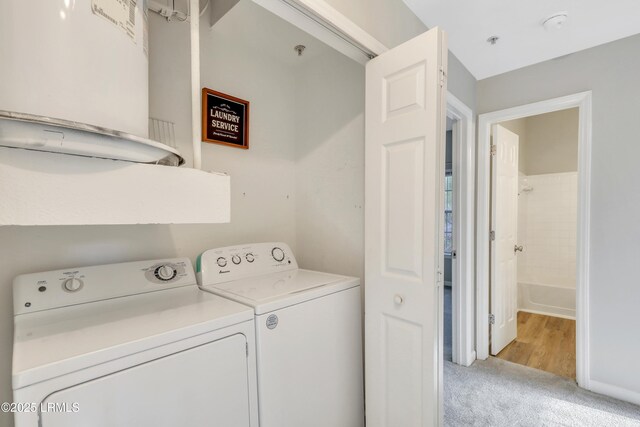 laundry area featuring light carpet and washing machine and clothes dryer