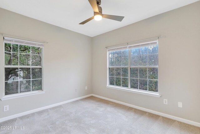 carpeted spare room with ceiling fan