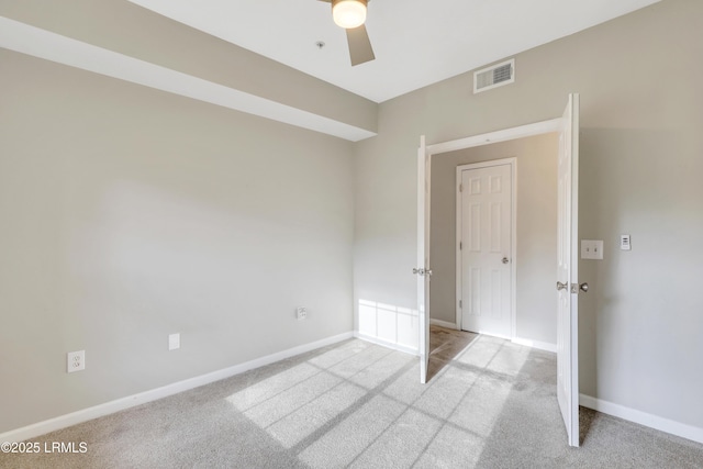 carpeted empty room with ceiling fan