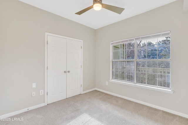 unfurnished bedroom with a closet, ceiling fan, and carpet flooring