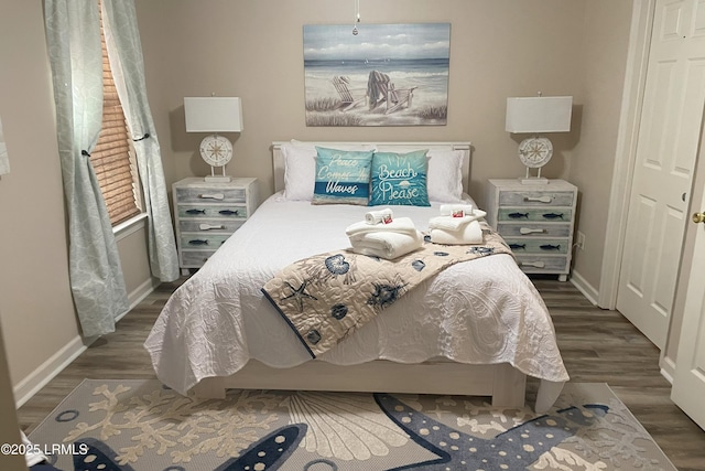 bedroom with dark hardwood / wood-style floors