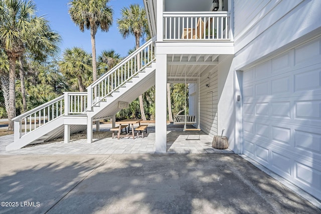 view of patio with a garage and stairs