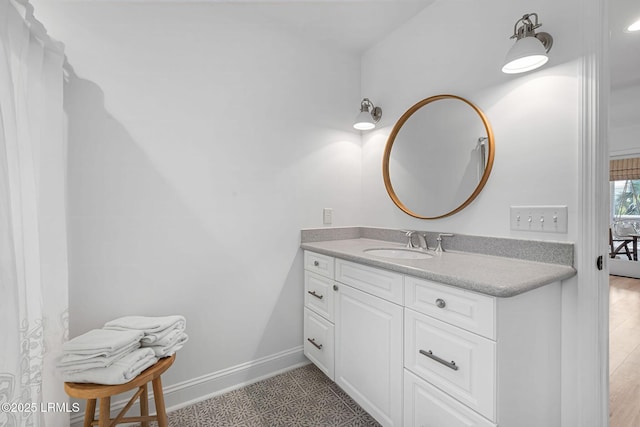 bathroom with baseboards and vanity