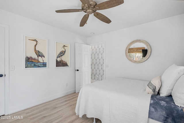 bedroom with ceiling fan, light wood-style flooring, and baseboards