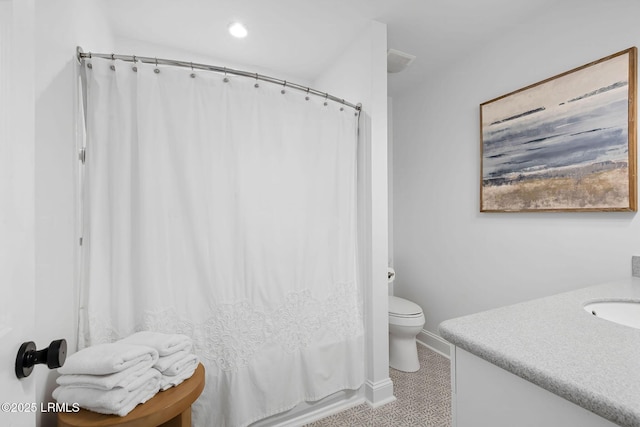 bathroom with toilet, baseboards, and vanity