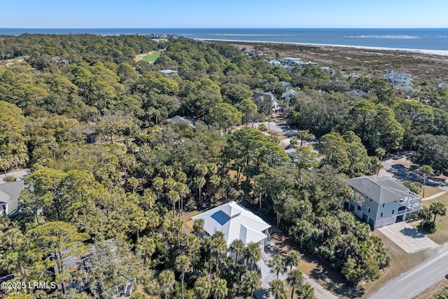 drone / aerial view featuring a water view and a wooded view