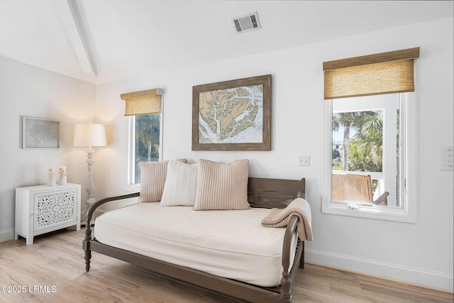 bedroom with visible vents, light wood finished floors, and multiple windows