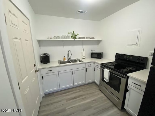 1712 Battery Park Dr, Port Royal, SC 29935 - kitchen with electric range, a sink, black microwave, and open shelves