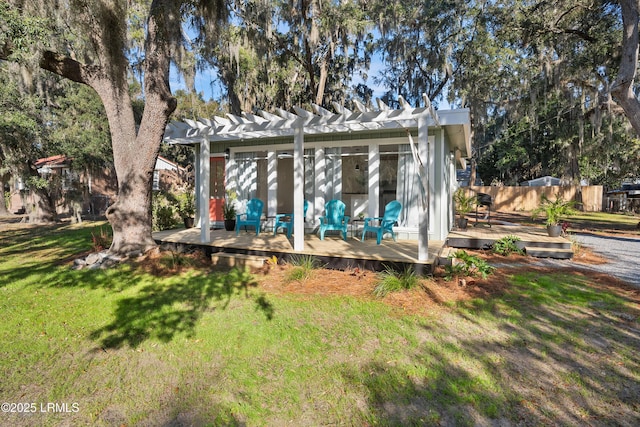 exterior space with a lawn and a pergola