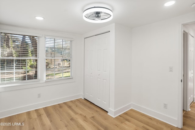 unfurnished bedroom with hardwood / wood-style flooring and a closet